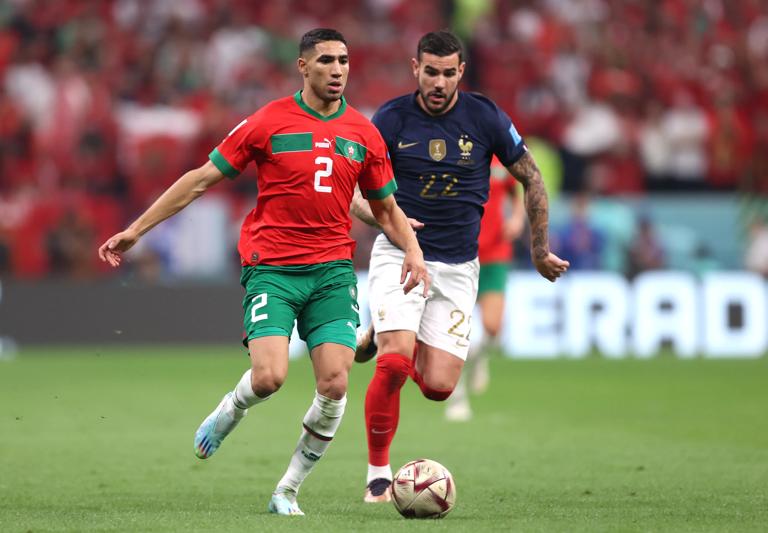 AL KHOR, QATAR - DECEMBER 14: Achraf Hakimi of Morocco controls the ball against Theo Hernandez of France during the FIFA World Cup Qatar 2022 semi final match between France and Morocco at Al Bayt Stadium on December 14, 2022 in Al Khor, Qatar. (Photo by Julian Finney/Getty Images)